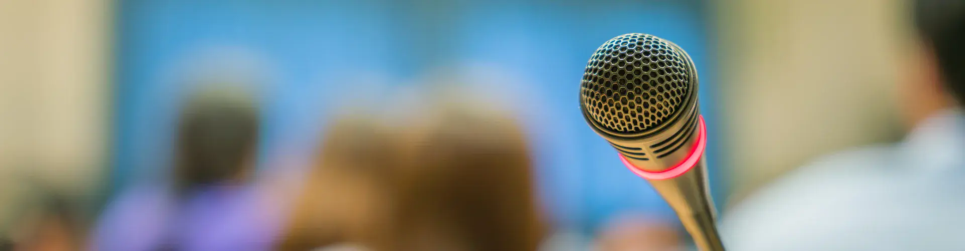 microphone-with-unfocused-background-audience.jpg (Credit: Image by Jannoon028 on Freepik)