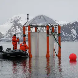 Researchers working on a mesocosm deployed for the ocean-acidification study