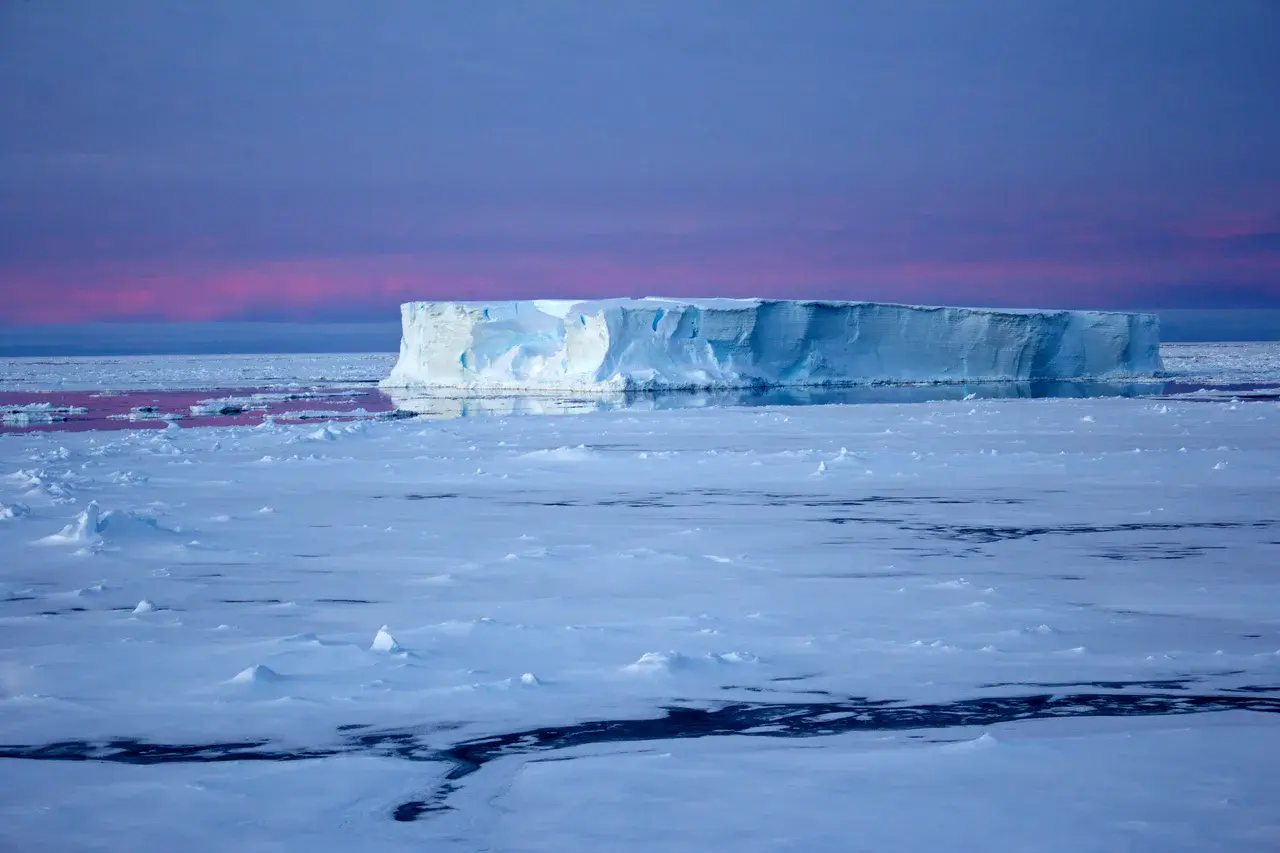 Tabular iceberg surrounded by sea ice in the Antarctic (Credit: Eva Nowatzki, distributed via imaggeo.egu.eu)