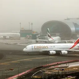 Airplane taxiing during a dust storm at Dubai International Airport.jpg