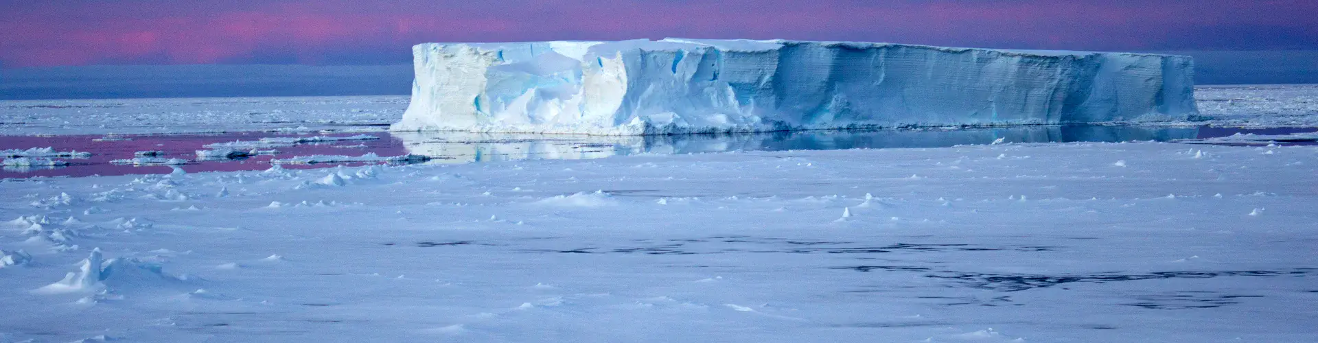Iceberg surrounded by sea ice in the Antarctic (Credit: Eva Nowatzki, distributed via imaggeo.egu.eu)